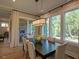 Bright dining room with large windows and a modern chandelier above a dark wood table at 97 August Trace Dr, Pittsboro, NC 27312
