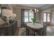 Bright dining room boasts stylish decor, wainscoting, and ample natural light, perfect for Gathering meals at 97 August Trace Dr, Pittsboro, NC 27312