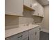 Well-organized laundry room with white cabinetry and ample counter space at 97 August Trace Dr, Pittsboro, NC 27312