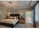 Serene main bedroom featuring stylish furnishings, soft lighting, and access to the outdoors at 97 August Trace Dr, Pittsboro, NC 27312