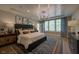 Spacious main bedroom with large windows, tray ceiling and elegant decor at 97 August Trace Dr, Pittsboro, NC 27312