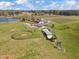 Aerial view of country property with a pond, barn, outbuildings, and green pastures at 97 Bailey Rd, Coats, NC 27521