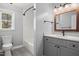 Modern bathroom with new shower and vanity, stylish gray walls and wood-look flooring at 97 Bailey Rd, Coats, NC 27521