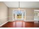 Bright dining room featuring a bay window, hardwood floors, and neutral paint at 97 Bailey Rd, Coats, NC 27521