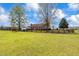 Beautiful farmhouse with a horse grazing on lush green pasture enclosed by a dark wooden fence showcasing idyllic country living at 97 Bailey Rd, Coats, NC 27521