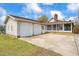 View of the home's exterior featuring a two-car garage and a well-maintained driveway at 97 Bailey Rd, Coats, NC 27521