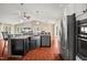 Well-designed kitchen with stainless steel appliances, a large island, and a sink overlooking the spacious living area at 97 Bailey Rd, Coats, NC 27521