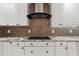 Modern kitchen with custom cabinets, granite countertops, and a sleek black range hood creating a stylish and functional cooking space at 97 Bailey Rd, Coats, NC 27521
