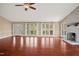 Spacious living room with hardwood floors, a charming fireplace, and ample natural light flooding through large windows at 97 Bailey Rd, Coats, NC 27521