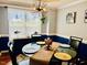 Elegant dining room with wainscoting, chandelier, and a glass-topped table set for formal dining at 10 Sapphire Dr, Sanford, NC 27332