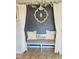 Charming entryway bench with throw pillows, decorative wall art, and tiled flooring at 10 Sapphire Dr, Sanford, NC 27332