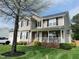 Charming two-story home with a well-manicured lawn and inviting front porch at 10 Sapphire Dr, Sanford, NC 27332