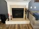 Close-up of a cozy fireplace with white tile surround and decorative accessories at 10 Sapphire Dr, Sanford, NC 27332
