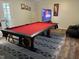 Spacious game room with a red pool table, mounted TV, and comfortable seating, perfect for entertaining at 10 Sapphire Dr, Sanford, NC 27332
