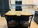 A beautiful kitchen with granite island and black chairs at 10 Sapphire Dr, Sanford, NC 27332