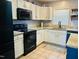 Modern kitchen features white cabinets, granite countertops, and black appliances at 10 Sapphire Dr, Sanford, NC 27332