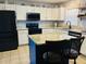 Well-lit kitchen boasts an island, granite counters, stainless steel appliances, and bright white cabinets at 10 Sapphire Dr, Sanford, NC 27332