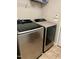 Bright laundry area featuring a modern washer and dryer with storage shelves above at 10 Sapphire Dr, Sanford, NC 27332