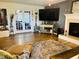 Spacious living room with a fireplace, TV, and french doors leading to another room at 10 Sapphire Dr, Sanford, NC 27332
