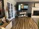 Well-lit living room with a fireplace, television, french doors, and modern decor at 10 Sapphire Dr, Sanford, NC 27332