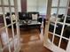 Sitting Room with French Doors, dark leather sofas and a glass table at 10 Sapphire Dr, Sanford, NC 27332