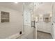 Bright bathroom featuring subway tile walls, a glass shower, and a double vanity with modern fixtures at 104 Perth Ct, Cary, NC 27511