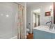 Bathroom with marble tile, tub and shower, blue vanity, and modern fixtures at 104 Perth Ct, Cary, NC 27511