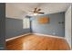 Bedroom features hardwood floors, natural light from a casement window, and a ceiling fan at 104 Perth Ct, Cary, NC 27511