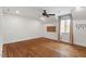 Bedroom with hardwood floors, a ceiling fan, a window, and unique wall decor at 104 Perth Ct, Cary, NC 27511