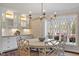 Breakfast nook with an adjacent kitchen featuring white cabinets and stainless appliances at 104 Perth Ct, Cary, NC 27511