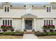 Elegant home featuring a gray front door flanked by flower boxes under leaded glass windows at 104 Perth Ct, Cary, NC 27511
