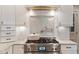 Close-up of a professional-grade stainless steel range with custom tile backsplash at 104 Perth Ct, Cary, NC 27511