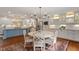 Eat-in kitchen featuring white cabinets, stainless appliances and an adjacent breakfast nook at 104 Perth Ct, Cary, NC 27511