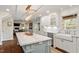 Gourmet kitchen featuring a large island, custom cabinetry, and modern lighting fixtures at 104 Perth Ct, Cary, NC 27511