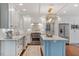 Bright, spacious kitchen with white cabinets, stainless steel appliances, and a blue kitchen island at 104 Perth Ct, Cary, NC 27511
