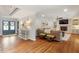 Open living room with exposed brick, hardwood floors, fireplace, and stylish decor at 104 Perth Ct, Cary, NC 27511