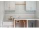 Mudroom details include white cabinetry, stylish sink, and gold faucet at 104 Perth Ct, Cary, NC 27511