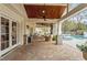 Covered patio with brick flooring leads to pool and backyard at 104 Perth Ct, Cary, NC 27511