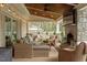 Covered patio features stone fireplace, television, and comfortable seating area at 104 Perth Ct, Cary, NC 27511