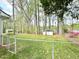 Private fenced backyard with a lush lawn, mature trees, and a storage shed for outdoor equipment at 1100 Medlin Dr, Cary, NC 27511