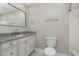 The bathroom features a granite countertop, a white vanity, and tile floors at 1100 Medlin Dr, Cary, NC 27511