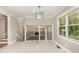 Elegant dining room with tile floors, stylish light fixture, and views into the living area at 1100 Medlin Dr, Cary, NC 27511