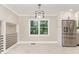 Bright dining area with tile floors, stainless steel refrigerator, and access to the kitchen at 1100 Medlin Dr, Cary, NC 27511