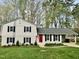 Charming two-story home featuring a red door, black shutters, and a well-manicured lawn at 1100 Medlin Dr, Cary, NC 27511