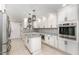 Beautiful kitchen with white cabinets, stainless steel appliances, island and granite countertops at 1100 Medlin Dr, Cary, NC 27511