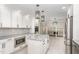 Stylish kitchen showcasing white cabinets, granite island, stainless steel appliances, and tiled backsplash at 1100 Medlin Dr, Cary, NC 27511