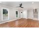 Bright and airy living room with hardwood floors, white trim, and a modern ceiling fan at 1100 Medlin Dr, Cary, NC 27511