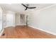 Open-concept living room featuring hardwood floors, neutral walls, and staircase access at 1100 Medlin Dr, Cary, NC 27511