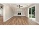 Bright living room featuring a fireplace, sliding glass doors, and vinyl floors at 1100 Medlin Dr, Cary, NC 27511