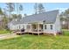 The backyard offers a spacious yard with a fire pit, deck, and patio, perfect for outdoor entertaining at 1165 Shonele Ln, Stem, NC 27581